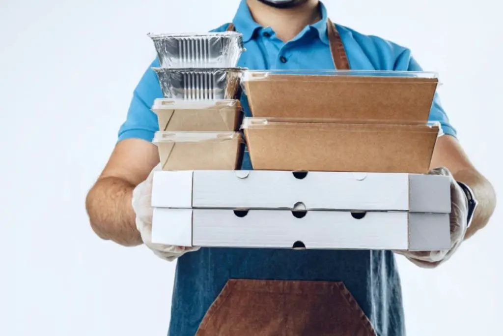 man in blue polo shirt with food delivery orders