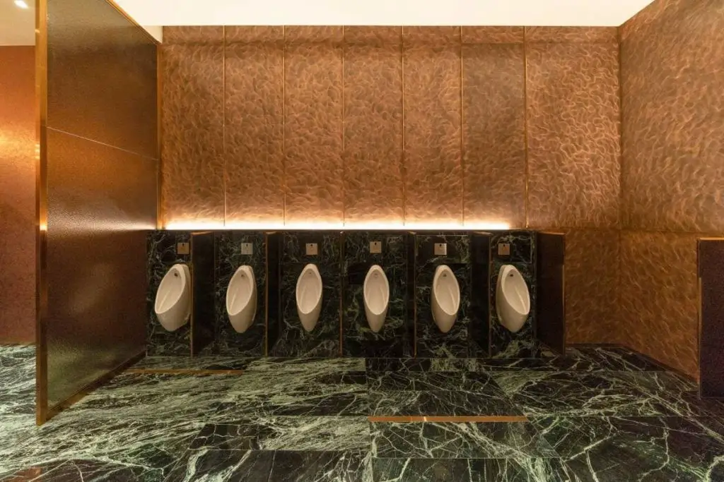 row of modern urinals men public toilet room