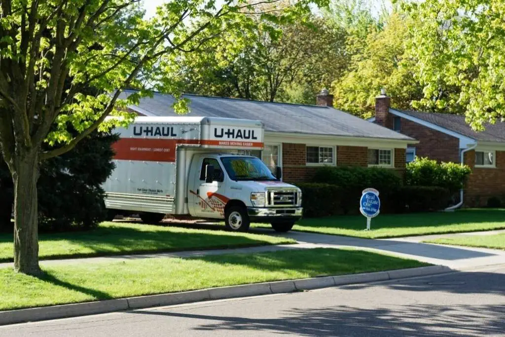 U-Haul rental van sits parked in the driveway of a home