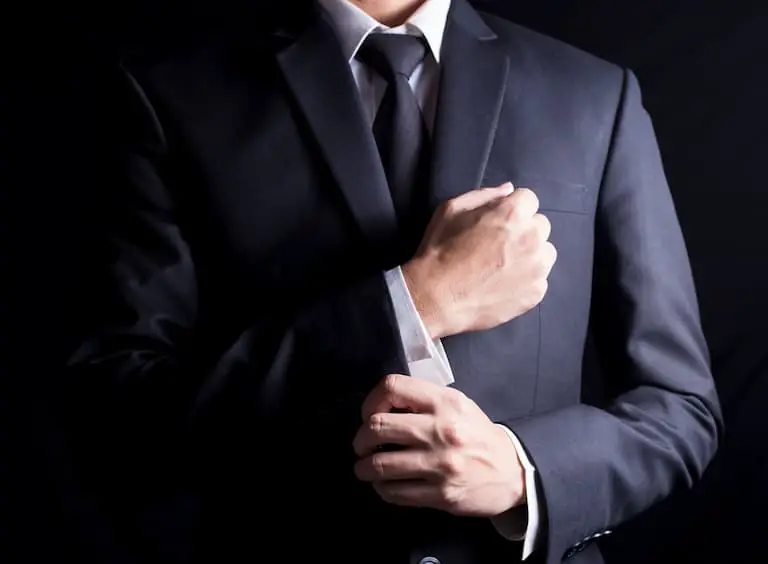 businessman fixing cufflinks his suit