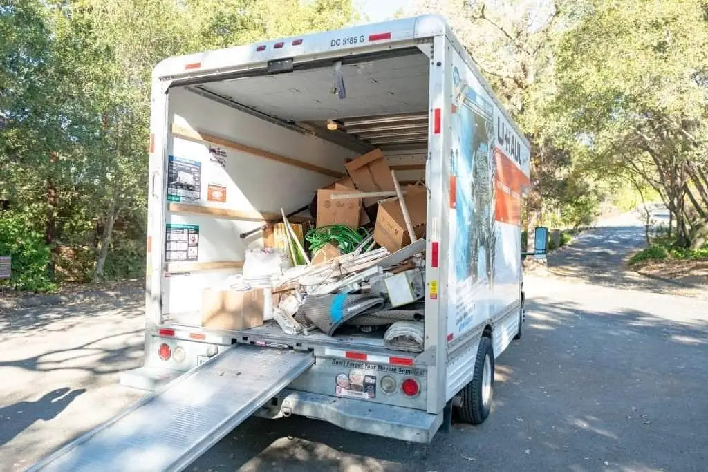 UHaul moving truck loaded with boxes and household waste and debris