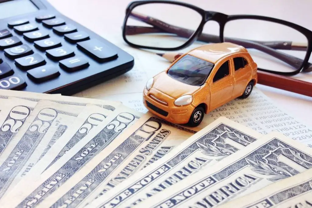 miniature car model, pencil, calculator, eyeglasses, money and savings account passbook