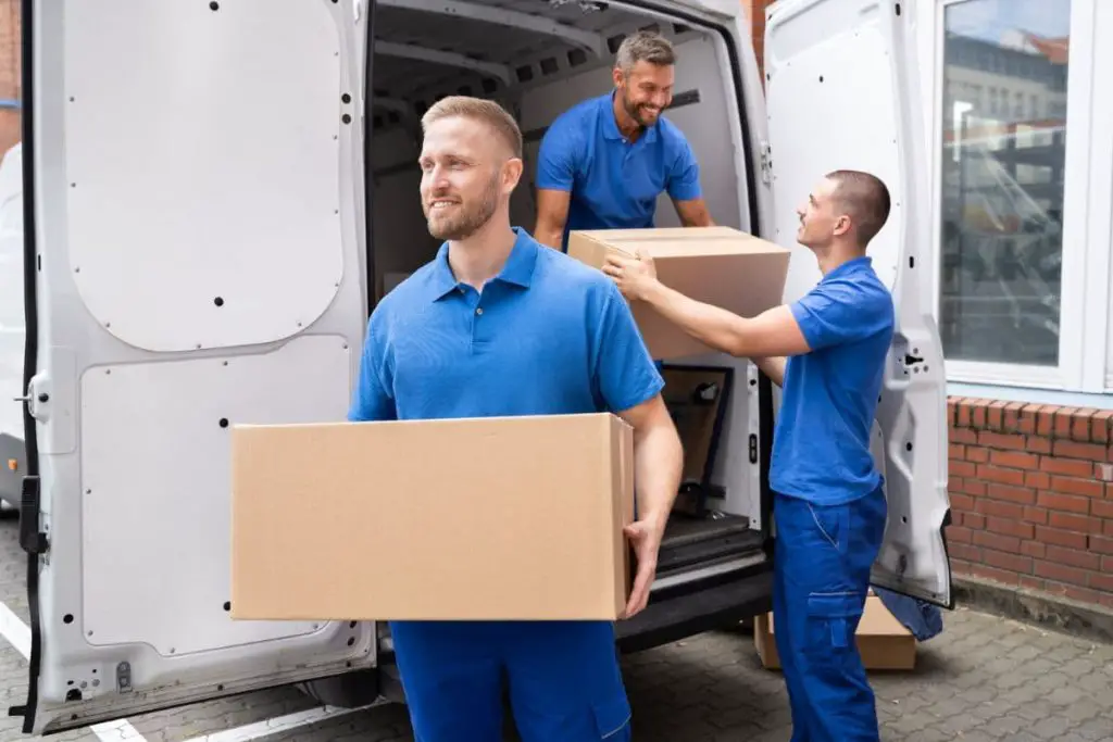 truck movers loading van carrying boxes and moving house