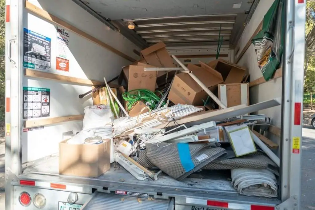 U-Haul moving truck loaded with boxes and household waste and debris